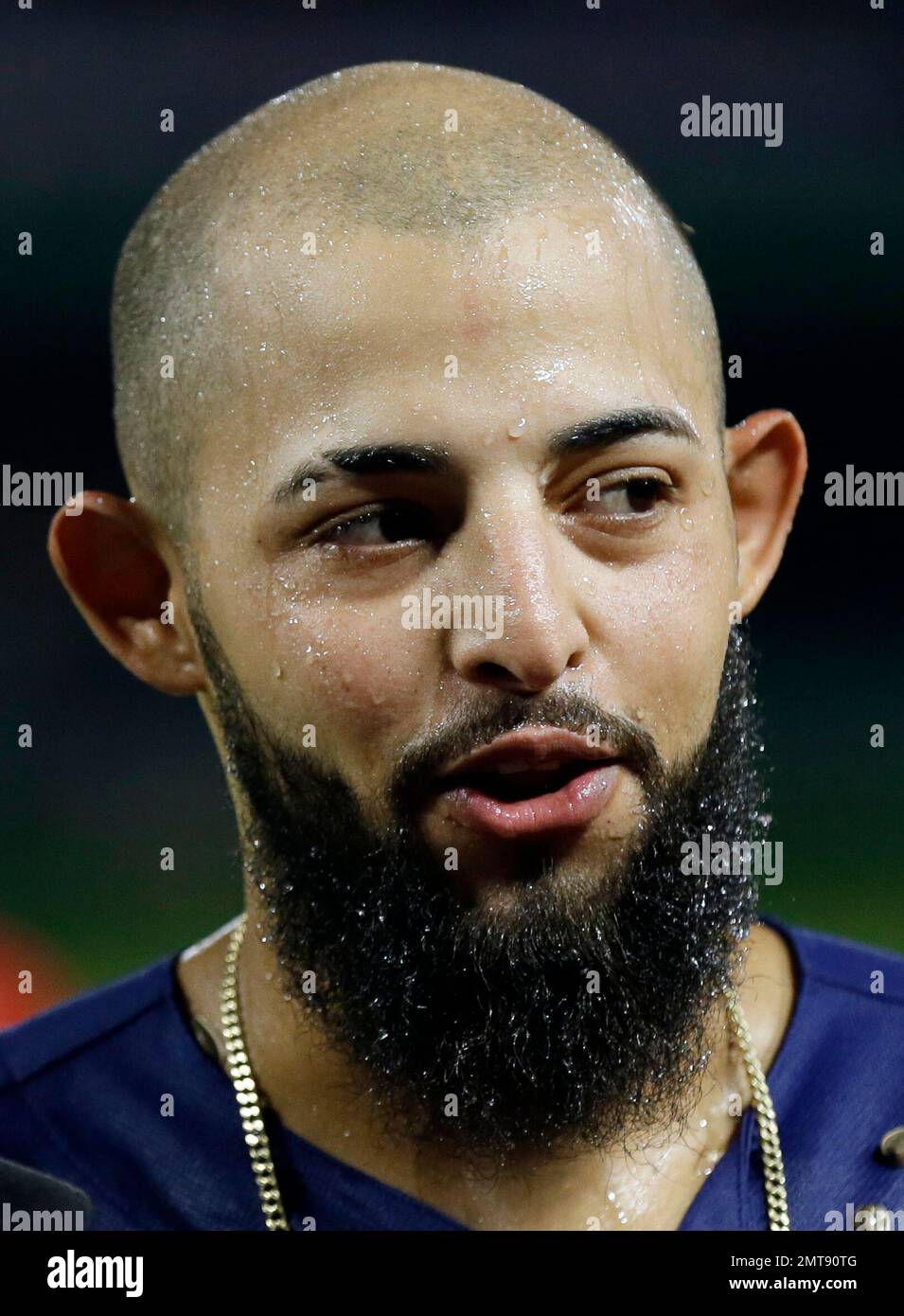 Texas Rangers' Rougned Odor gives a post game interview dripping wet after  being doused by teammates following their 10-0 win against the Los Angeles  Angels in a baseball game, Friday, July 7
