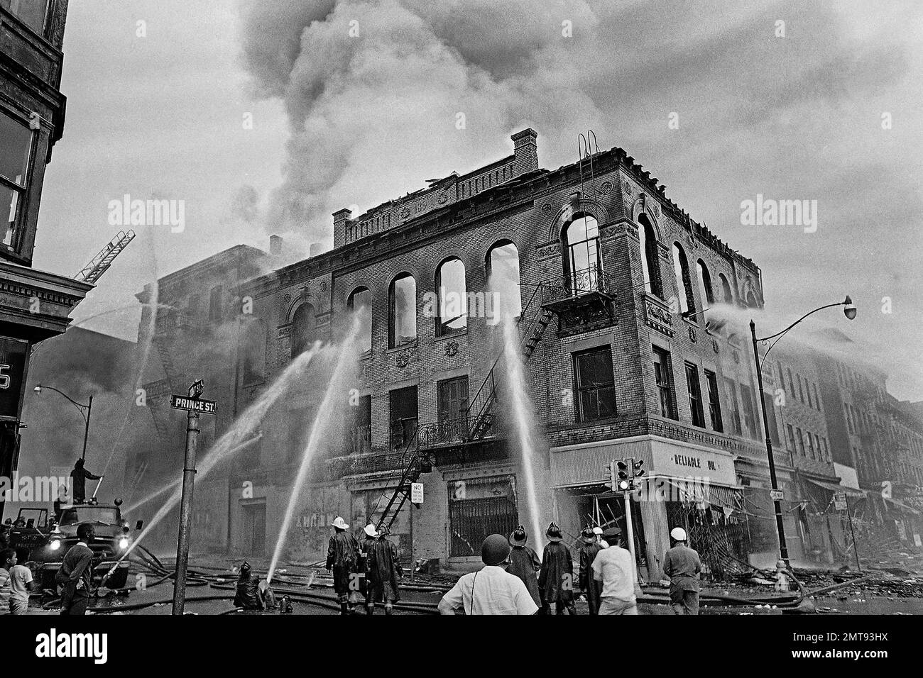 FILE - In this July 15, 1967 file photo, firefighters direct streams of ...
