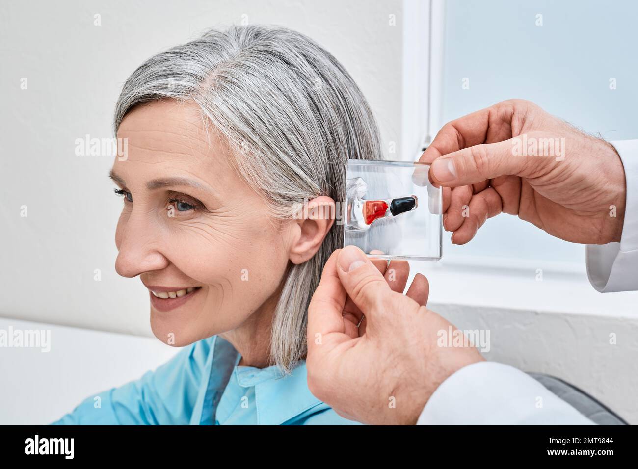 Invisible InTheCanal hearing aids. Doctor demonstrates display stand