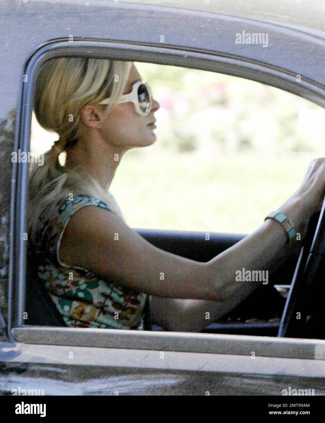 EXCLUSIVE!! Paris Hilton drives out of her gated community, the first  pictures of Hilton since the odd and aggressive acts that occurred at her  home this morning. According to reports a man