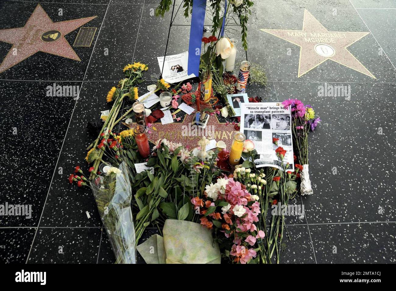 Fans visit and leave tokens of their love at a growing memorial for the