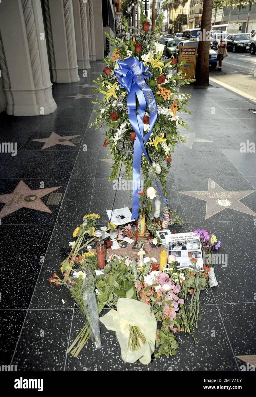 Fans visit and leave tokens of their love at a growing memorial for the