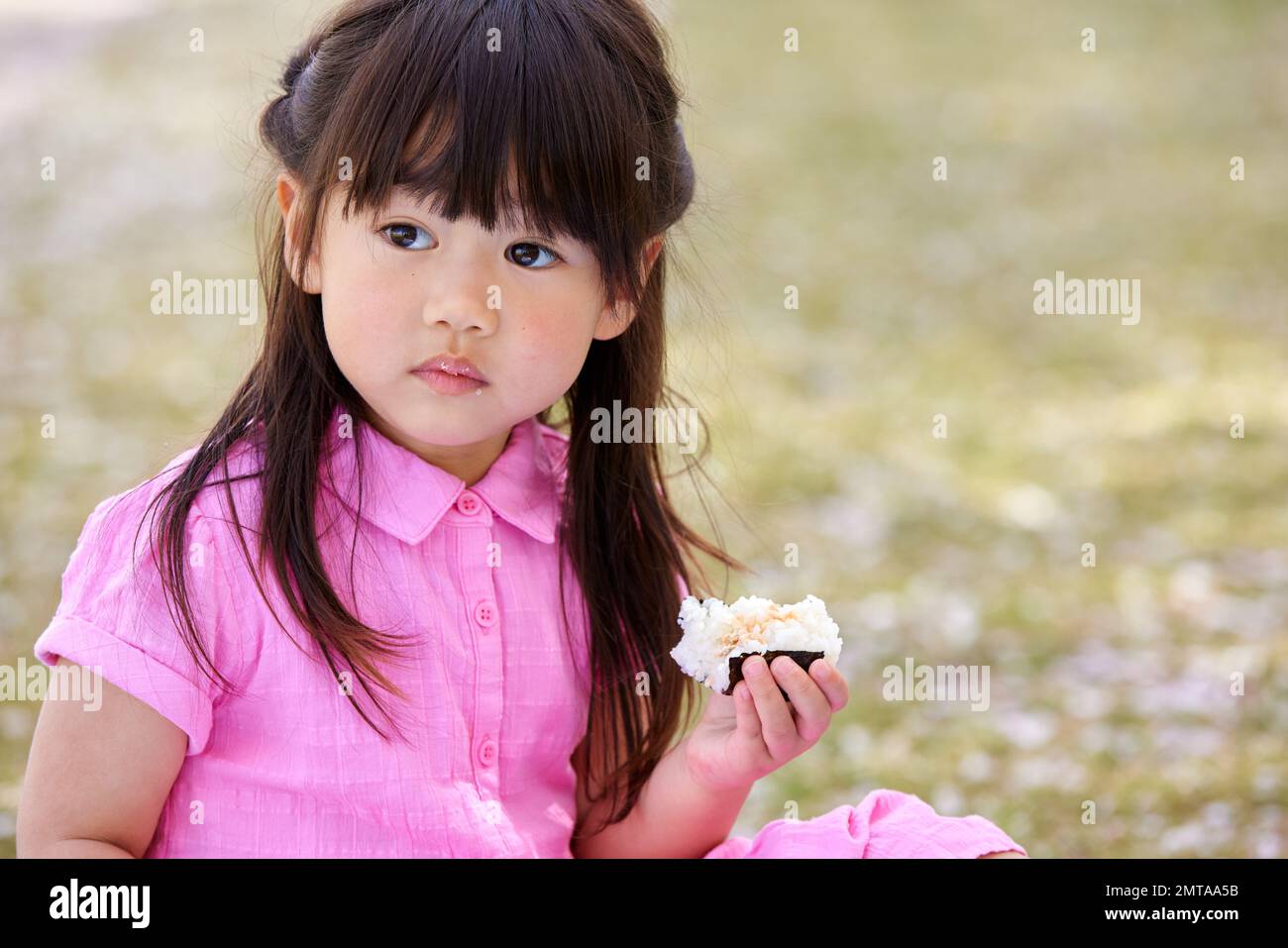 Japanese kid portrait with blooming cherry blossoms Stock Photo