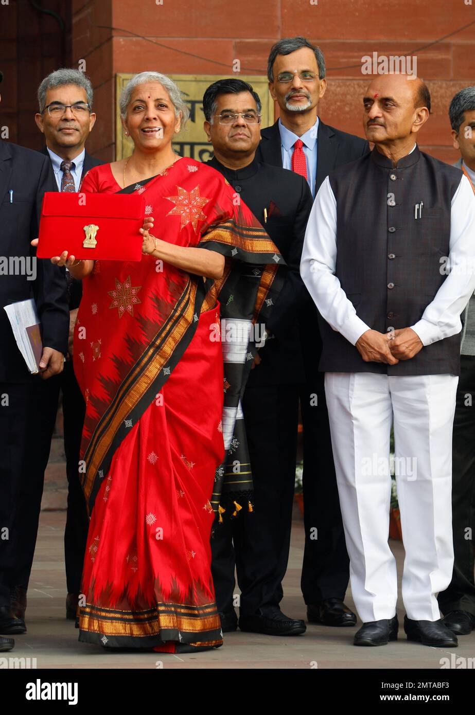 New Delhi, India. 01st Feb, 2023. Union Minister for Finance, Nirmala Sitharaman, Left, Union Minister of Sate Bhagwat Kishanrao Karad, Right, with other officials pose for photographs before she leaves her office (Finance Ministry), for the President's House before present the annual Budget for the year 2023-24 in the Parliament in New Delhi. Nirmala Sitharaman will be presenting her fifth union Budget. Credit: SOPA Images Limited/Alamy Live News Stock Photo
