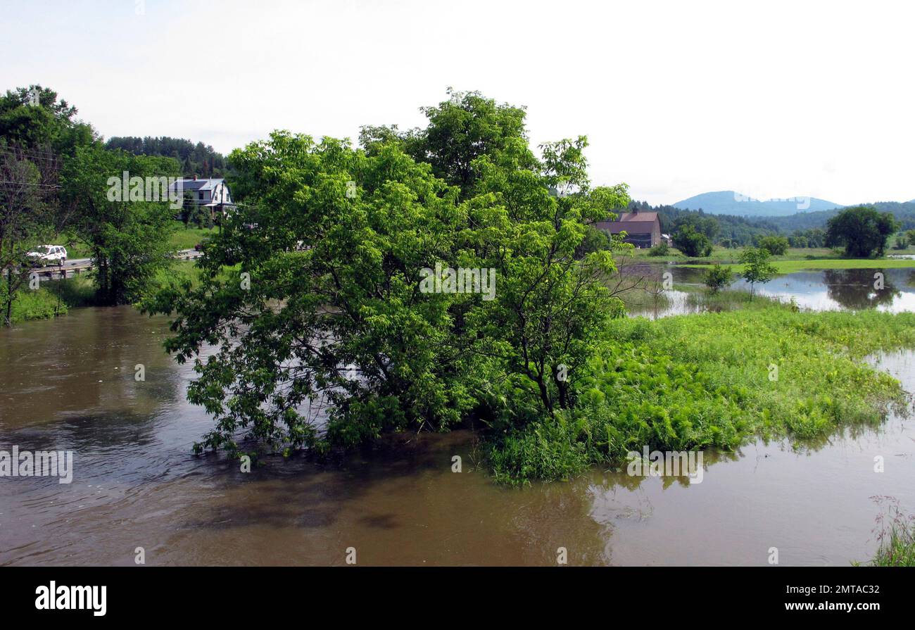 A section of the Winooski River floods a farm field in Marshfield, Vt