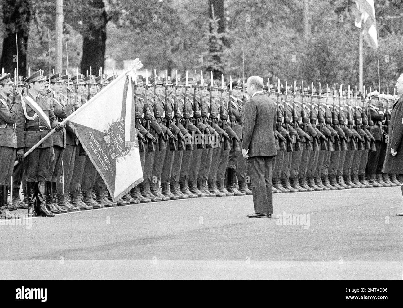 President Gerald Ford stands at attention in front of the Polish flag as Polish soldiers stand sharply at attention with eyes right during arrival ceremonies at Warsaw, July 28, 1975. (AP Photo) Stock Photo