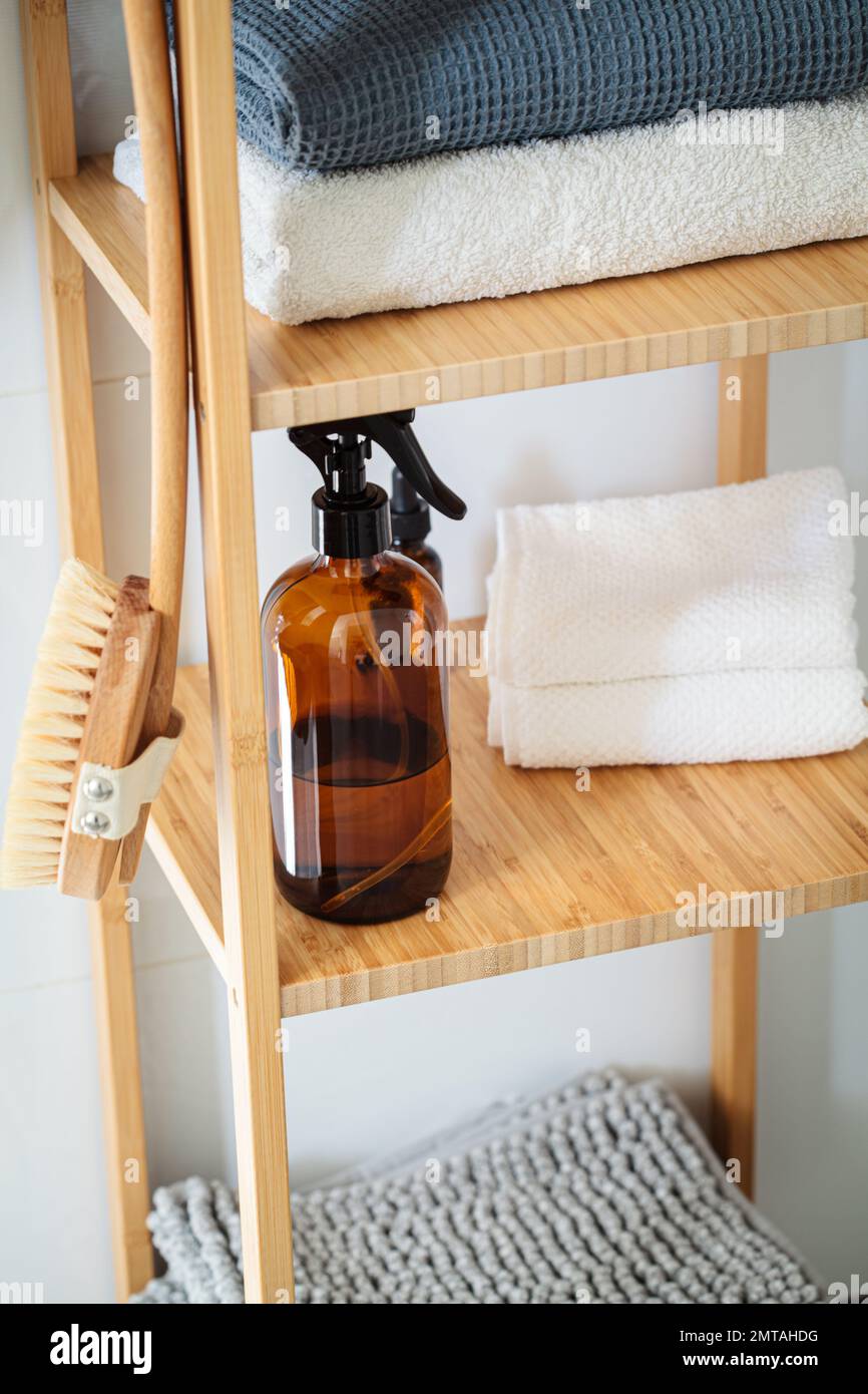 Wooden shelving in the bathroom with towels and bathroom accessories