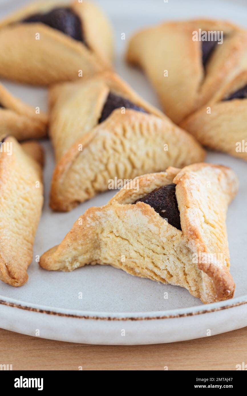 Hamantaschen cookies with chocolate for purim, close-up. Traditional Jewish dessert. Stock Photo