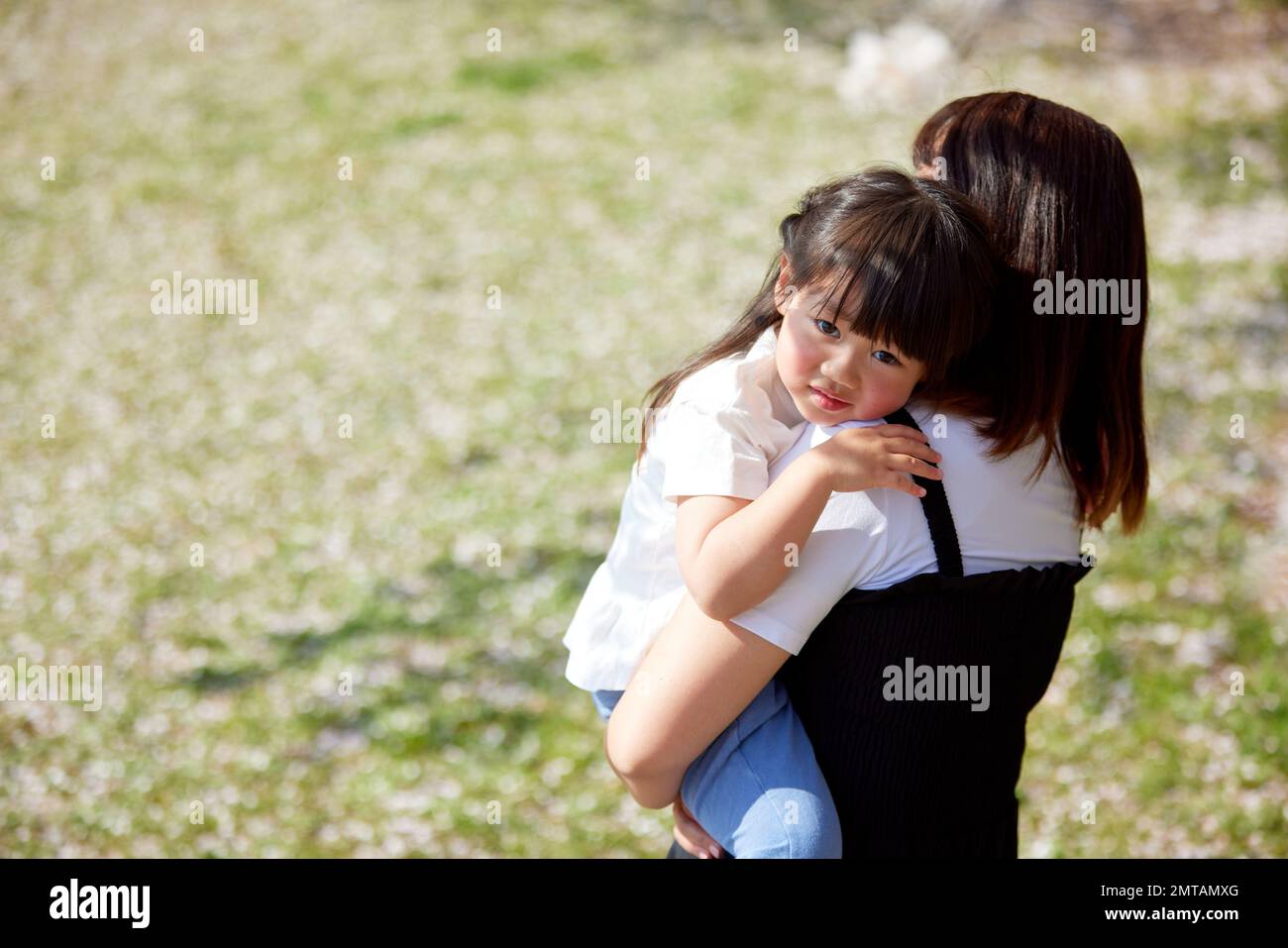 Japanese kid and mother in a city park Stock Photo