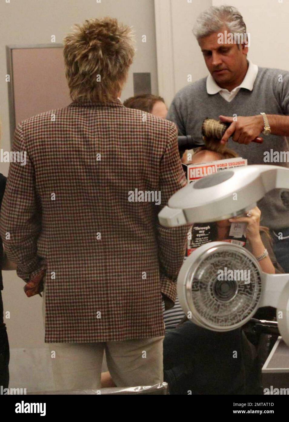 Legendary pop rock star Rod Stewart patiently waits while pregnant wife