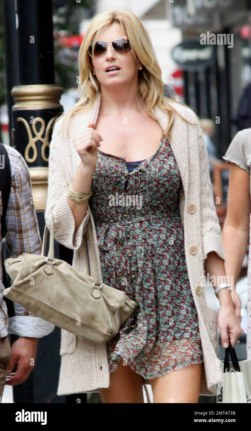 EXCLUSIVE!! Penny Lancaster, third wife of veteran singer Rod Stewart, appears to be reading a hand drawn map as she and some friends make their way to World Hair Colourist of the Year Daniel Galvin's hair salon in London the day after her husband performed at the O2 Arena.  Penny, 39, seemed to walk confidently in her sheer floral mini dress and tan cowboy boots paired with a matching cardigan and handbag. London, UK. 07/29/10. Stock Photo