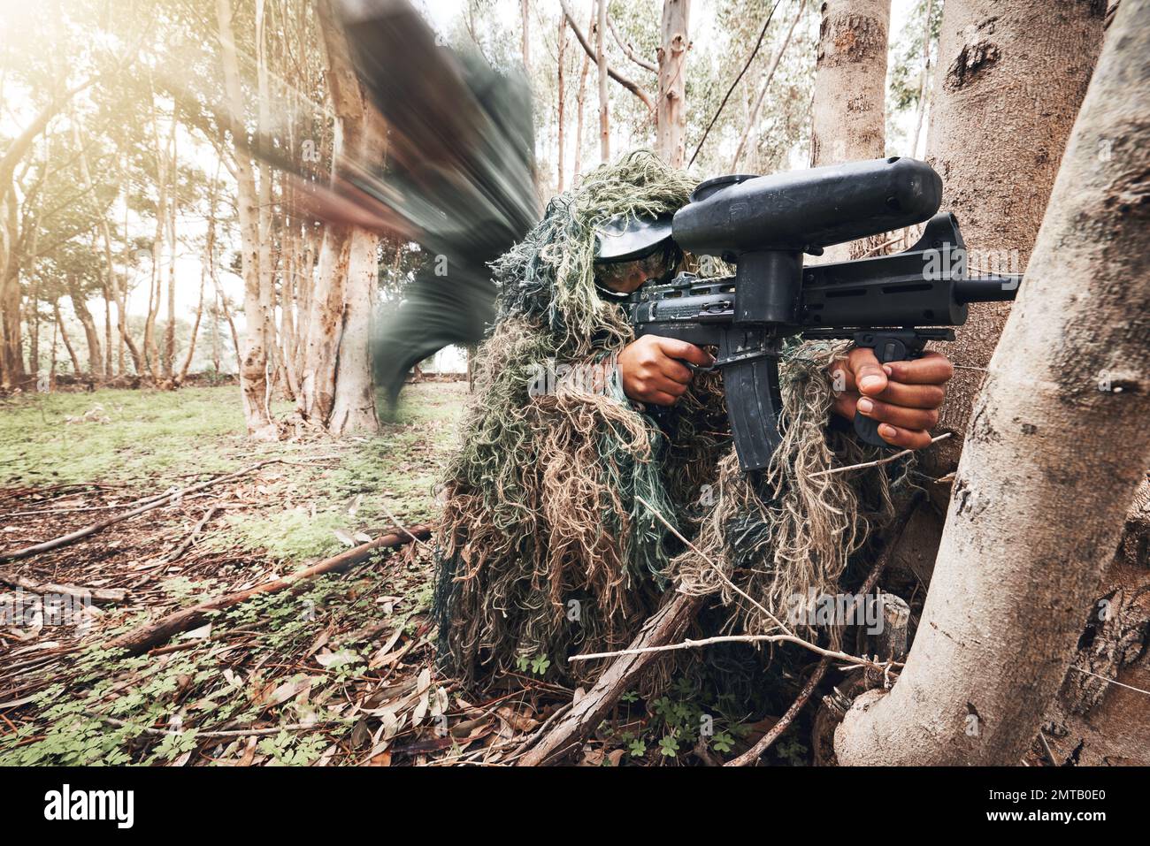 Paintball gun, forrest men and aim by trees for outdoor war game
