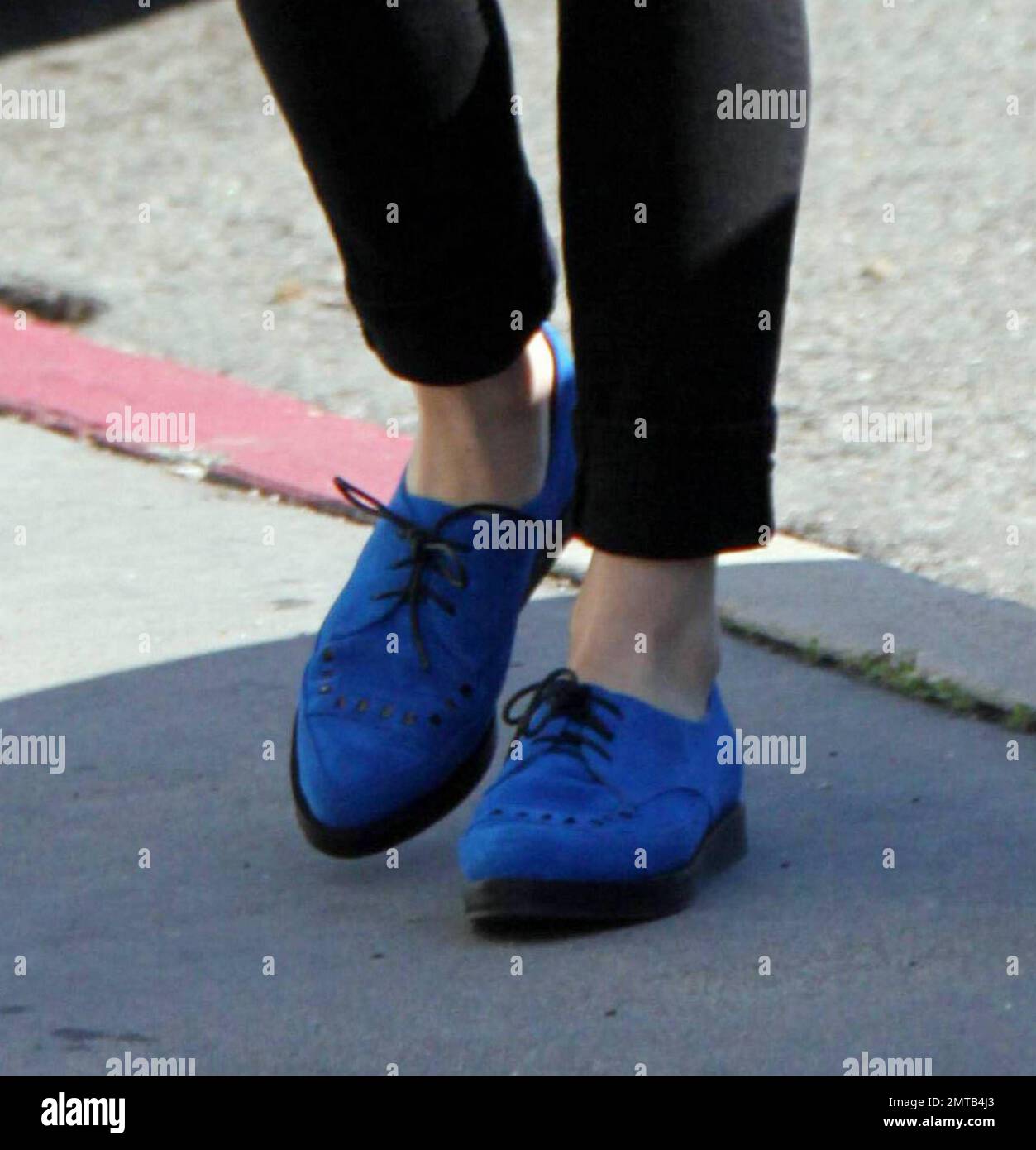 Newly engaged couple Katy Perry and Russell Brand went furniture shopping for their new home on Melrose at Orange .  Katy sucked on a lollipop as the two left the store. The couple dress sense was very similiar with Perry wearing blue suede shoes and a waistcoat.  Los Angeles, CA. 1/23/10. Stock Photo