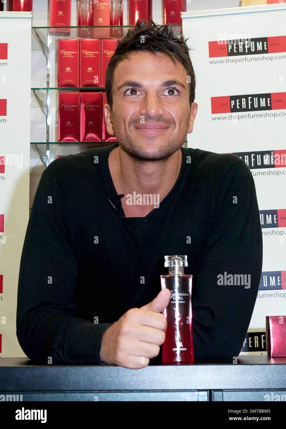 After a quick shirt change and half hour drive, singer and reality TV star Peter Andre appears at The Perfume Shop in Elms Shopping Centre in High Wycombe for an autograph session, launching his new fragrance for women, Mysterious Girl.  Earlier in the day Peter attended a photo call at The Chimes Shopping Centre in Uxbridge.  And while Peter has been busy maintaining his musical and merchandise career, ex-wife Katie Price appears to have been nurturing her new husband Alex Reid's professional mixed martial arts fighting career; she was seen ringside cheering Alex on last week during his UFC B Stock Photo