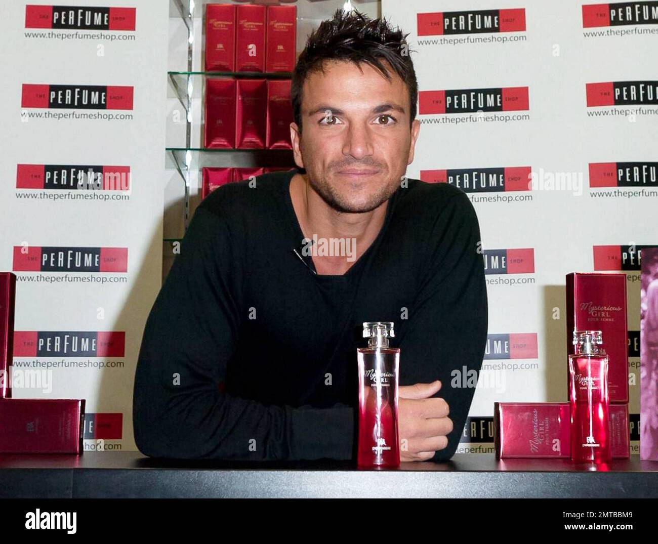 After a quick shirt change and half hour drive, singer and reality TV star Peter Andre appears at The Perfume Shop in Elms Shopping Centre in High Wycombe for an autograph session, launching his new fragrance for women, Mysterious Girl.  Earlier in the day Peter attended a photo call at The Chimes Shopping Centre in Uxbridge.  And while Peter has been busy maintaining his musical and merchandise career, ex-wife Katie Price appears to have been nurturing her new husband Alex Reid's professional mixed martial arts fighting career; she was seen ringside cheering Alex on last week during his UFC B Stock Photo