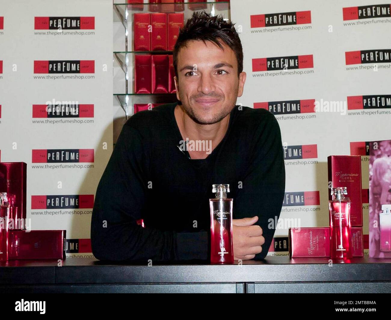 After a quick shirt change and half hour drive, singer and reality TV star Peter Andre appears at The Perfume Shop in Elms Shopping Centre in High Wycombe for an autograph session, launching his new fragrance for women, Mysterious Girl.  Earlier in the day Peter attended a photo call at The Chimes Shopping Centre in Uxbridge.  And while Peter has been busy maintaining his musical and merchandise career, ex-wife Katie Price appears to have been nurturing her new husband Alex Reid's professional mixed martial arts fighting career; she was seen ringside cheering Alex on last week during his UFC B Stock Photo