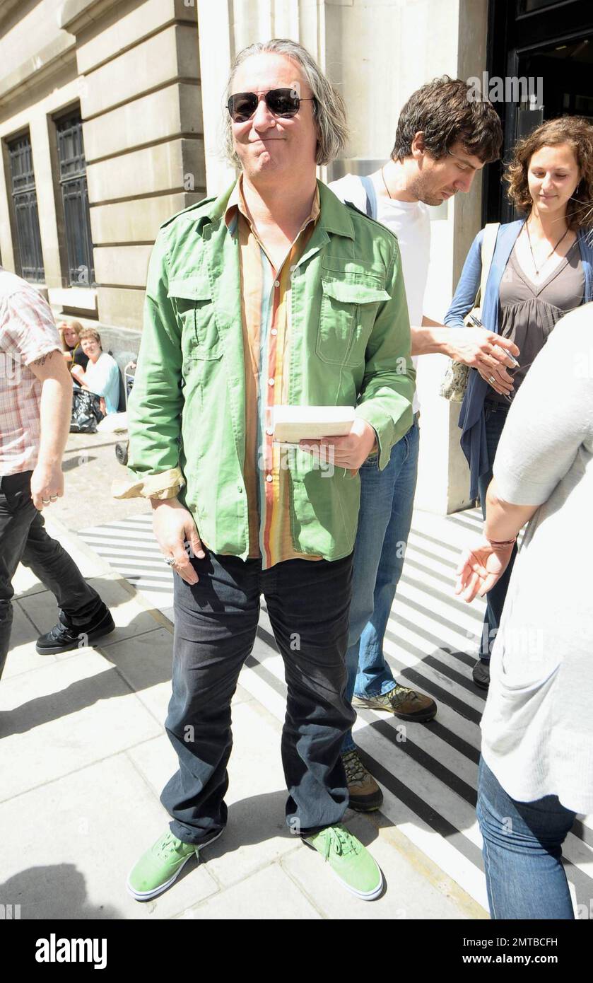 REM guitarist Peter Buck wears a green shirt and matching green shoes