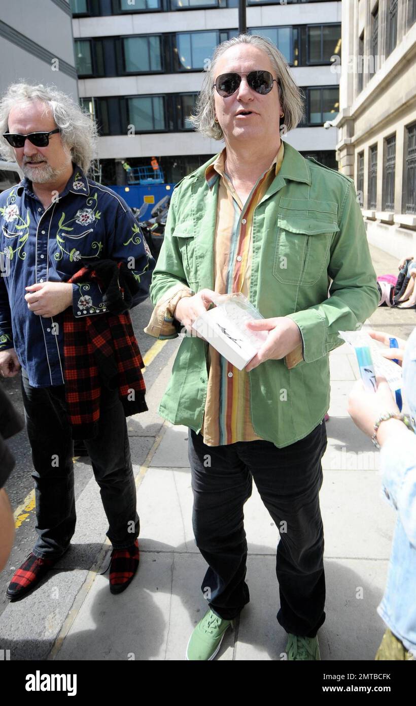 REM guitarist Peter Buck wears a green shirt and matching green shoes