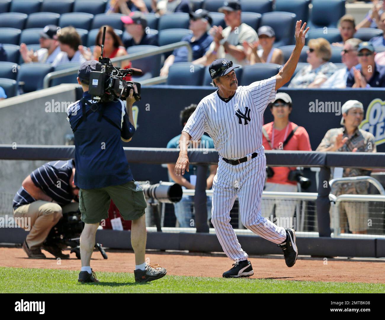 Former New York Yankee Ron Guidry waves during OldTimers' Day at