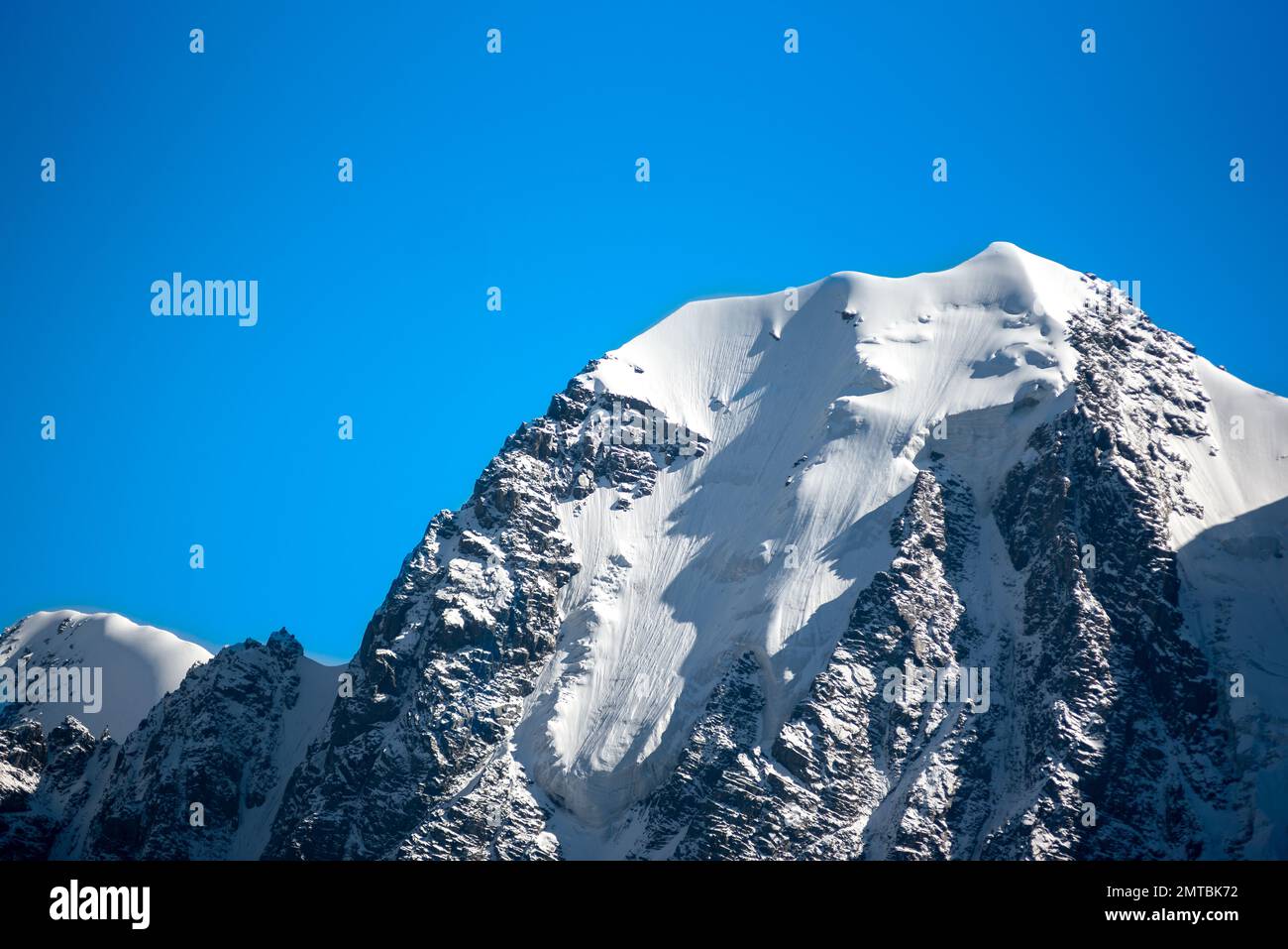 Panorama of the tongue of a high mountain glacier with snow in Altai. Top Fairy Tale. Vignetting effect Stock Photo