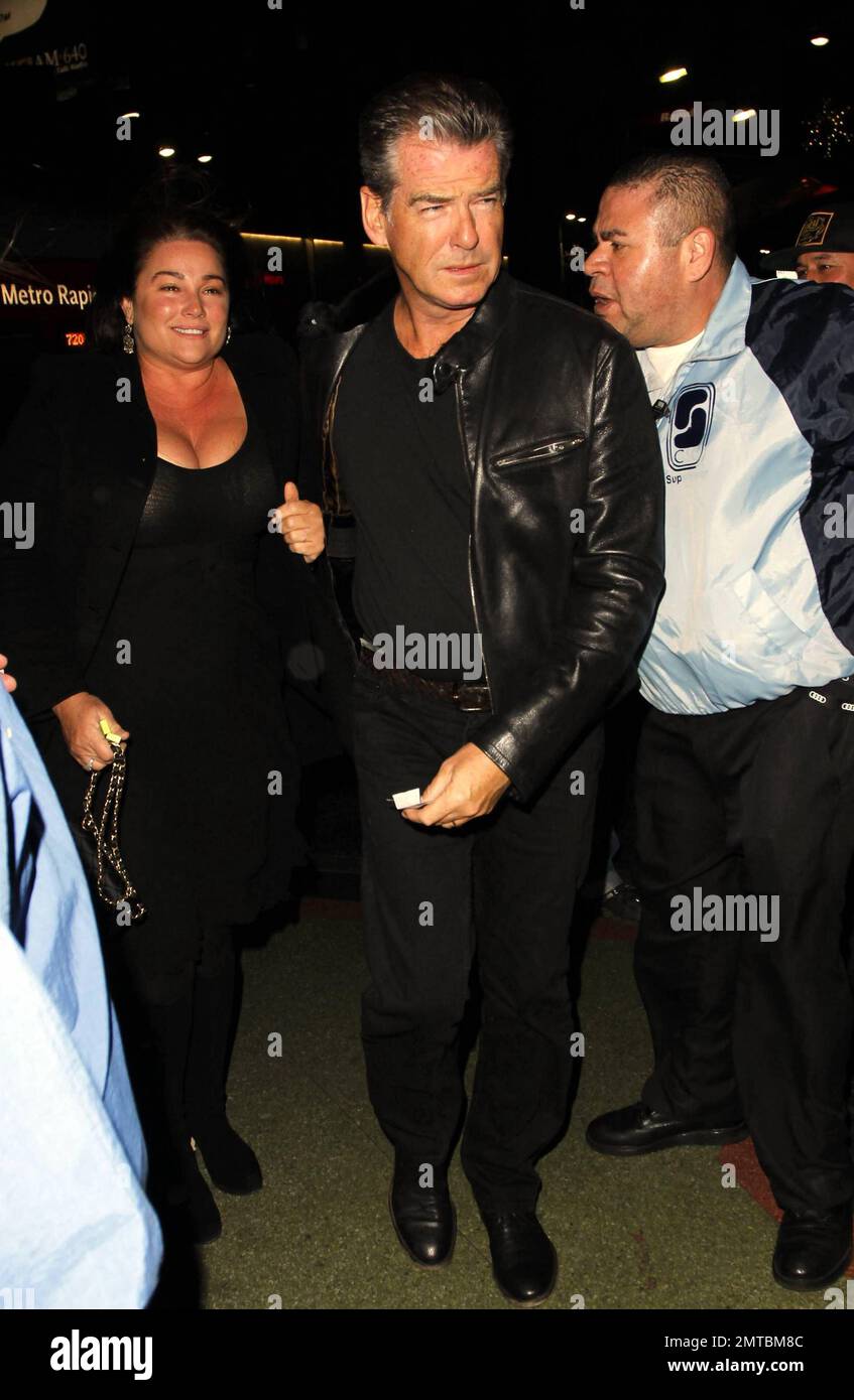 Pierce Brosnan signs autographs as he arrives at the Sting concert at
