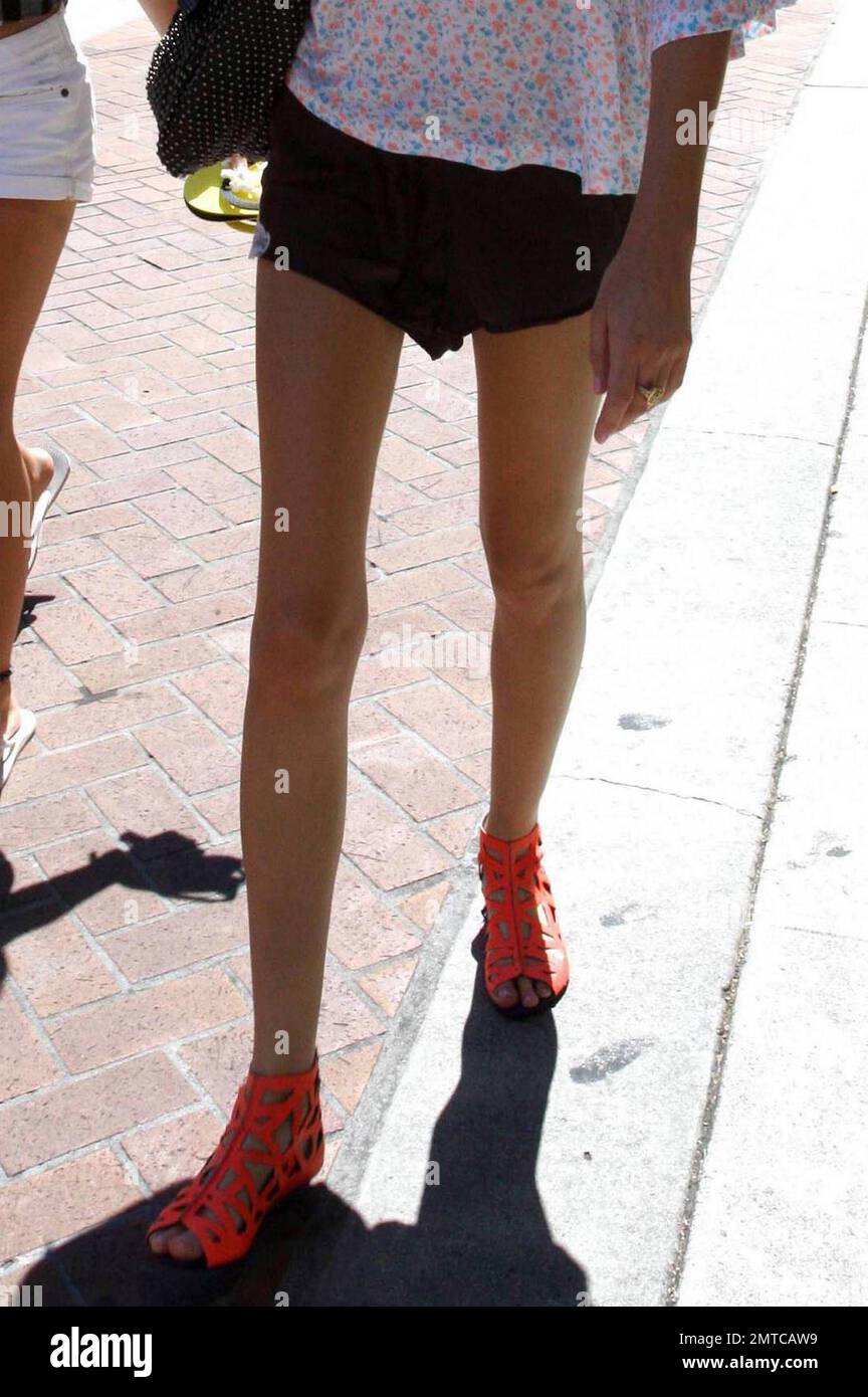 Super slender reality actress turned fashion designer, Whitney Port,  flashes her lean legs in a pair of black shorts that look akin to French  style cami-knickers. Port paired them with a loose