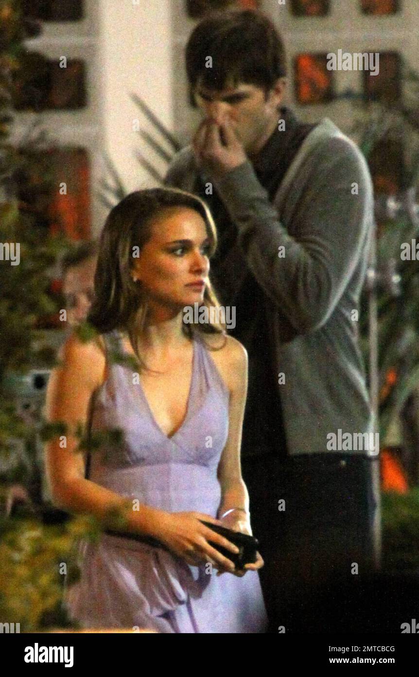Actress Natalie Portman appears very cold as she and actor Ashton Kutcher film a night scene for their new movie No Strings In between scenes Portman wore pants with her purple cocktail