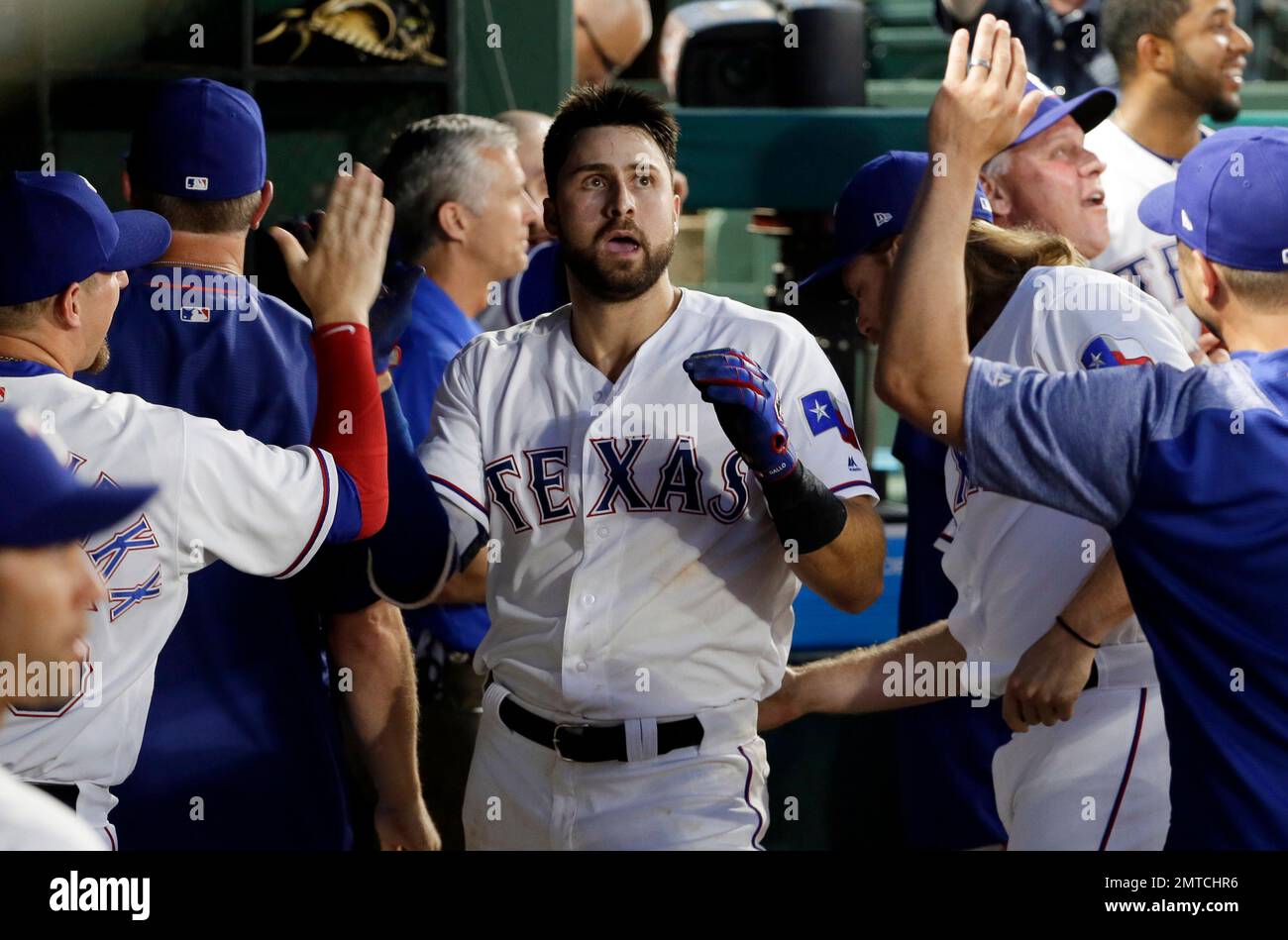 Texas Rangers' Joey Gallo, center, is congratulated in the dugout after  hitting a solo home run off Toronto Blue Jays' Joe Biagini during the fifth  inning of a baseball game, Wednesday, June