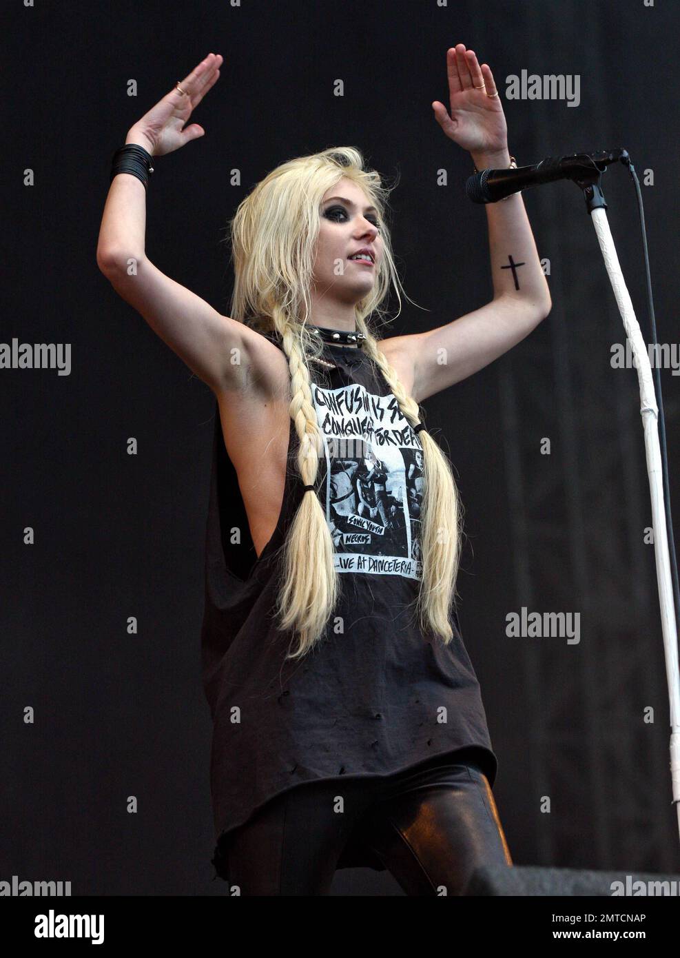 Wearing black tape crossed over her nipples, singer Taylor Momsen