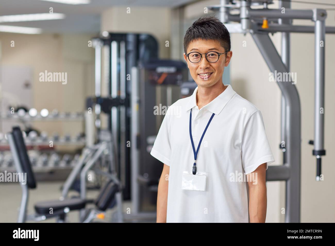 Japanese trainer at indoor gym Stock Photo Alamy