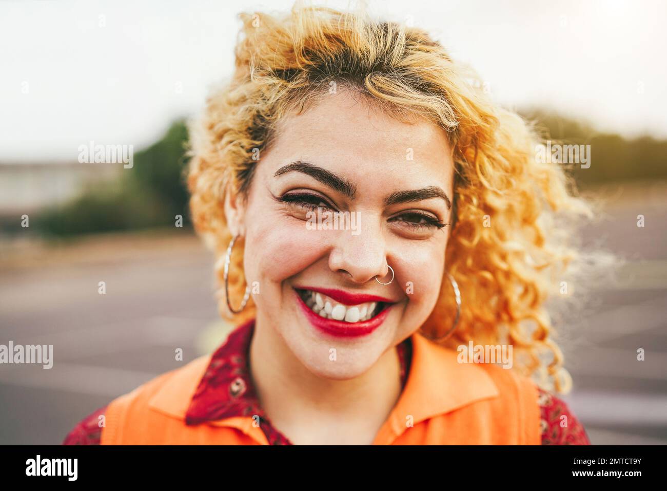 Bohemian young girl smiling on camera outdoor - Main focus on eyes Stock Photo