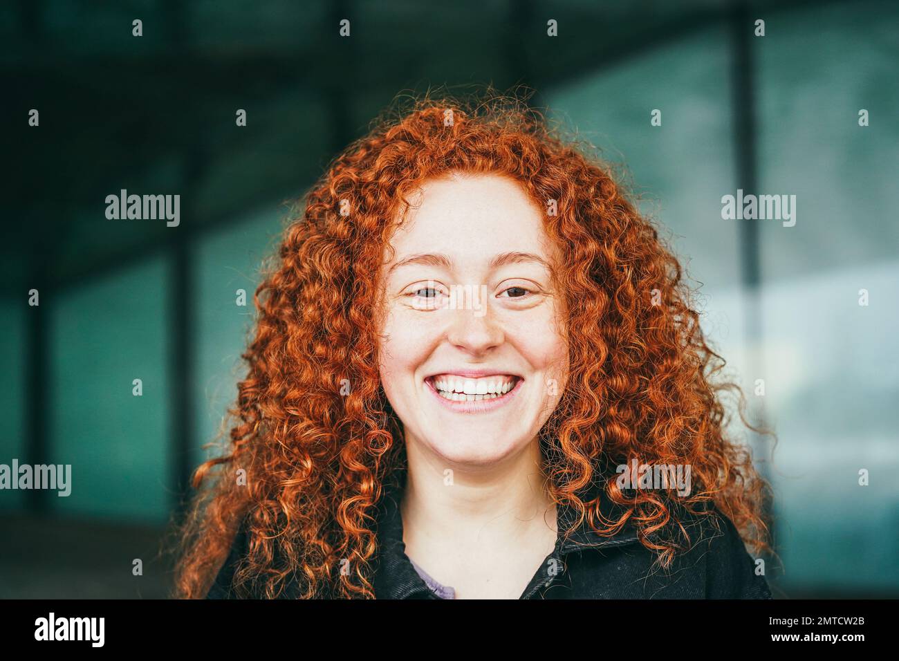 Happy red hair girl smiling on camera outdoor - Focus on face Stock Photo