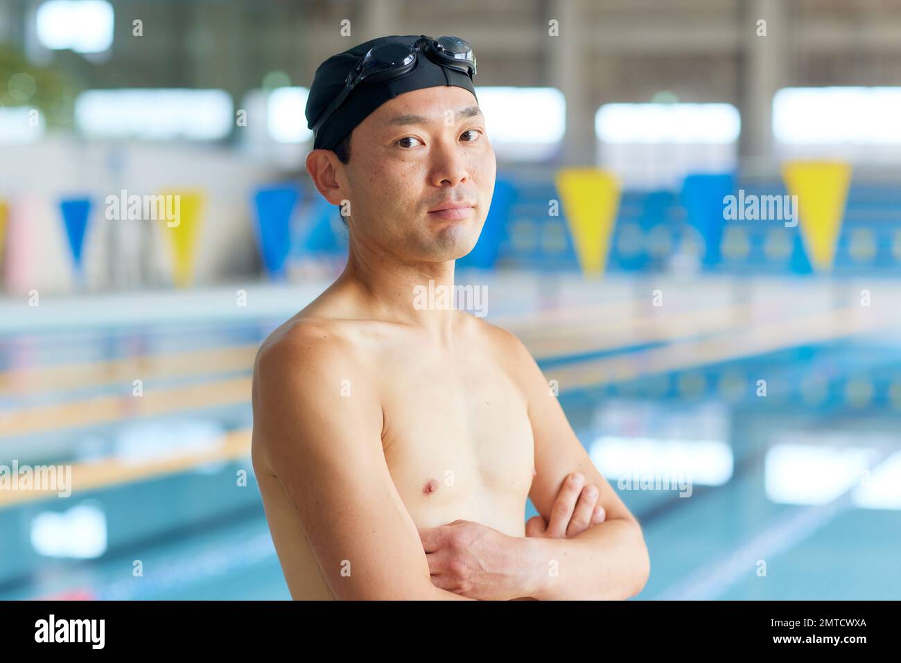 Japanese man at indoor swimming pool Stock Photo