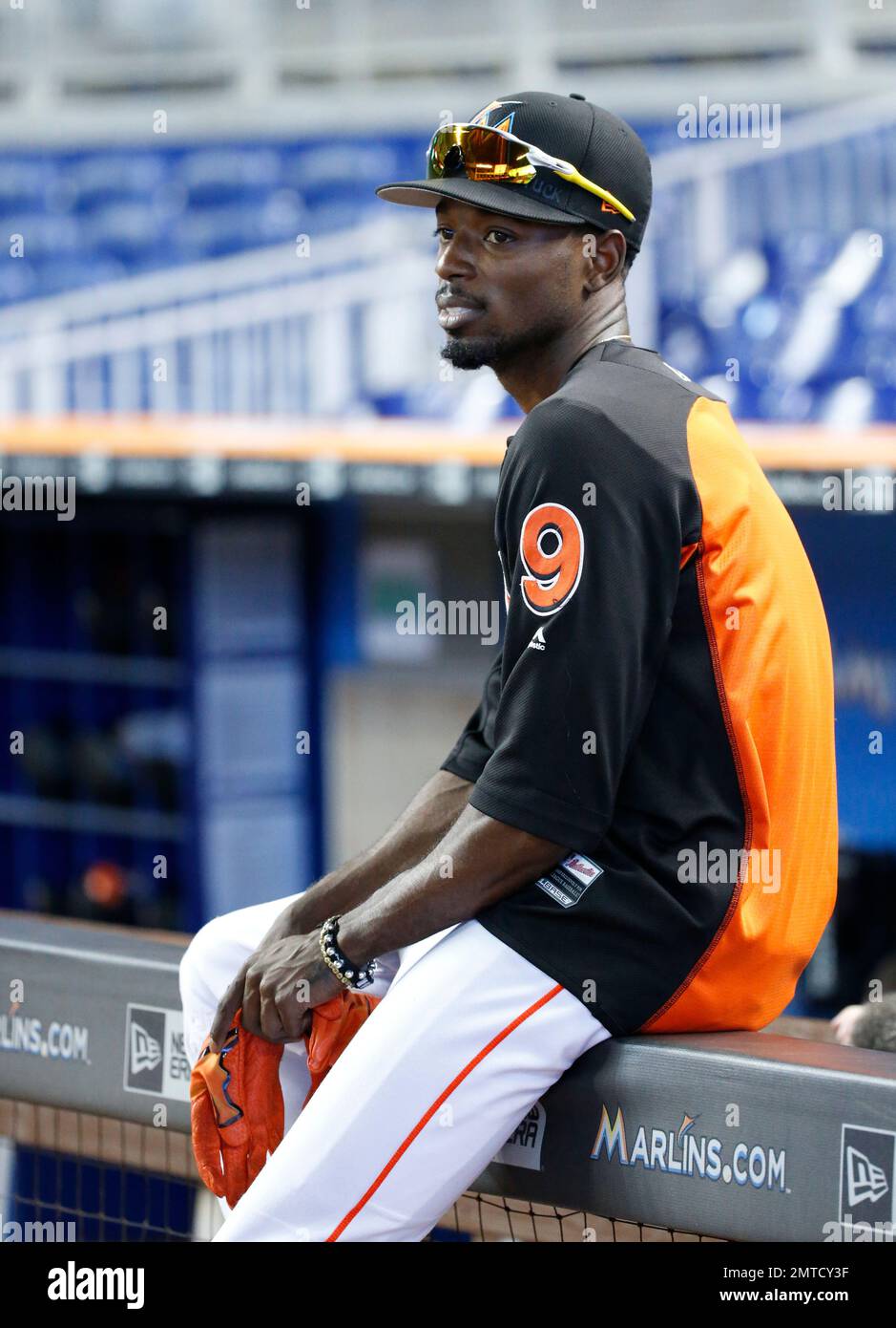 Miami Marlins' Dee Gordon puts on his batting gloves during batting  practice before the start of a baseball game against the Washington  Nationals, Tuesday, June 20, 2017, in Miami. (AP Photo/Wilfredo Lee