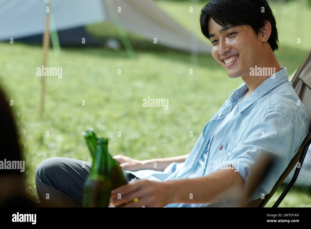 Young Japanese man at campsite Stock Photo Alamy