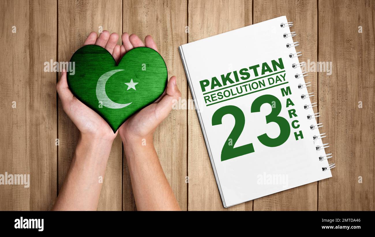 A human hand holding a heart with the Pakistan flag symbol. Pakistan  Resolution Day Stock Photo - Alamy, image size:1300x821