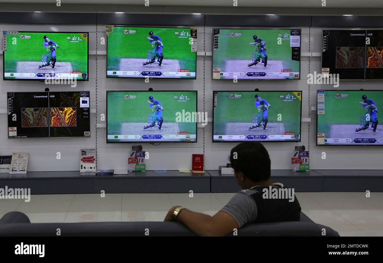 An Indian man watches a live telecast of the Champions Trophy cricket final match between India and Pakistan from Oval in London, at an electronics store in Bangalore, India, Sunday, June 18,