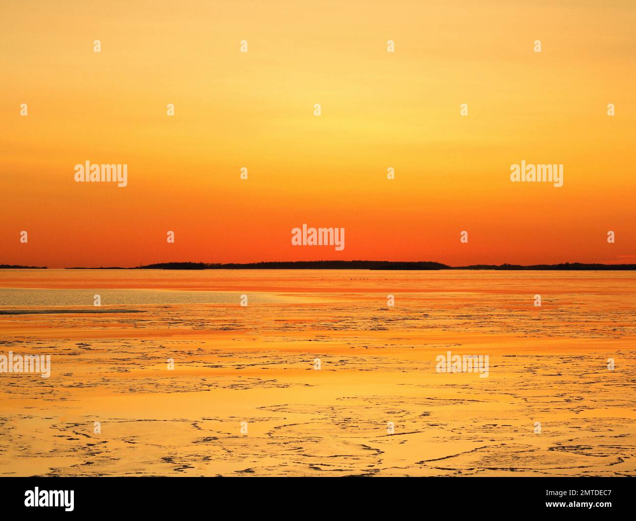 A landscape scene of golden hour sunset sky reflecting on the sea water ...