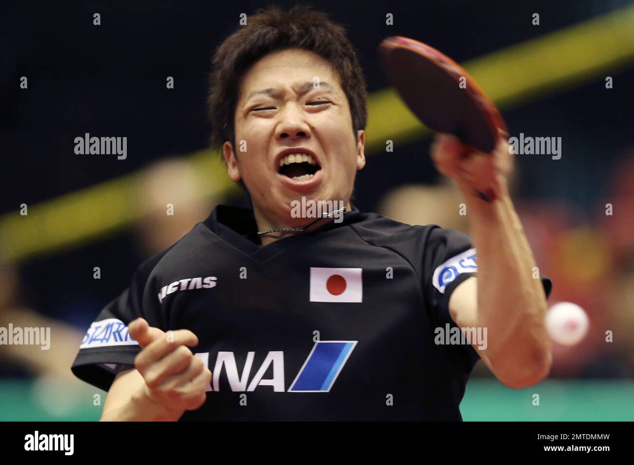 Jun Mizutani of Japan returns a shot against Lee Sangsu of South Korea