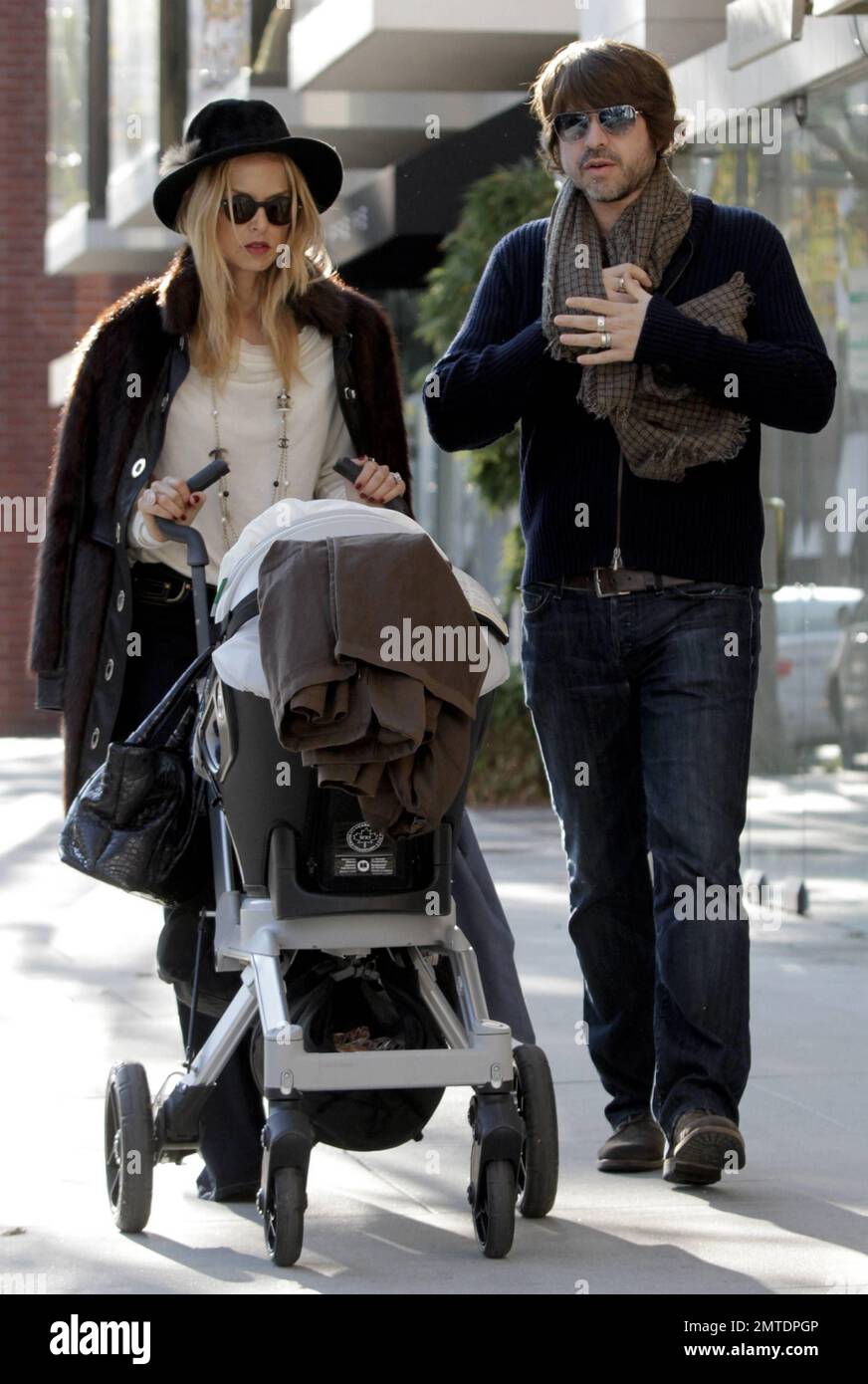 EXCLUSIVE!! Stylist to the stars Rachel Zoe and husband Rodger Berman take their 8 month old baby, Skylar, out for a stroll in Beverly Hills. The 40 year old stylish mother was seen pushing a stroller carrying baby Skylar while wearing a black hat, brown furry jacket, tan top with blue jeans and accessorized with a Chanel necklace and dark sunglasses. The stylist who counts Cameron Diaz, Jennifer Garner and Kate Hudson among her A-list clientele recently admitted that her cute son has become her favorite person to style for because he as 'no opinion' on the hundred of designer outfits she gets Stock Photo