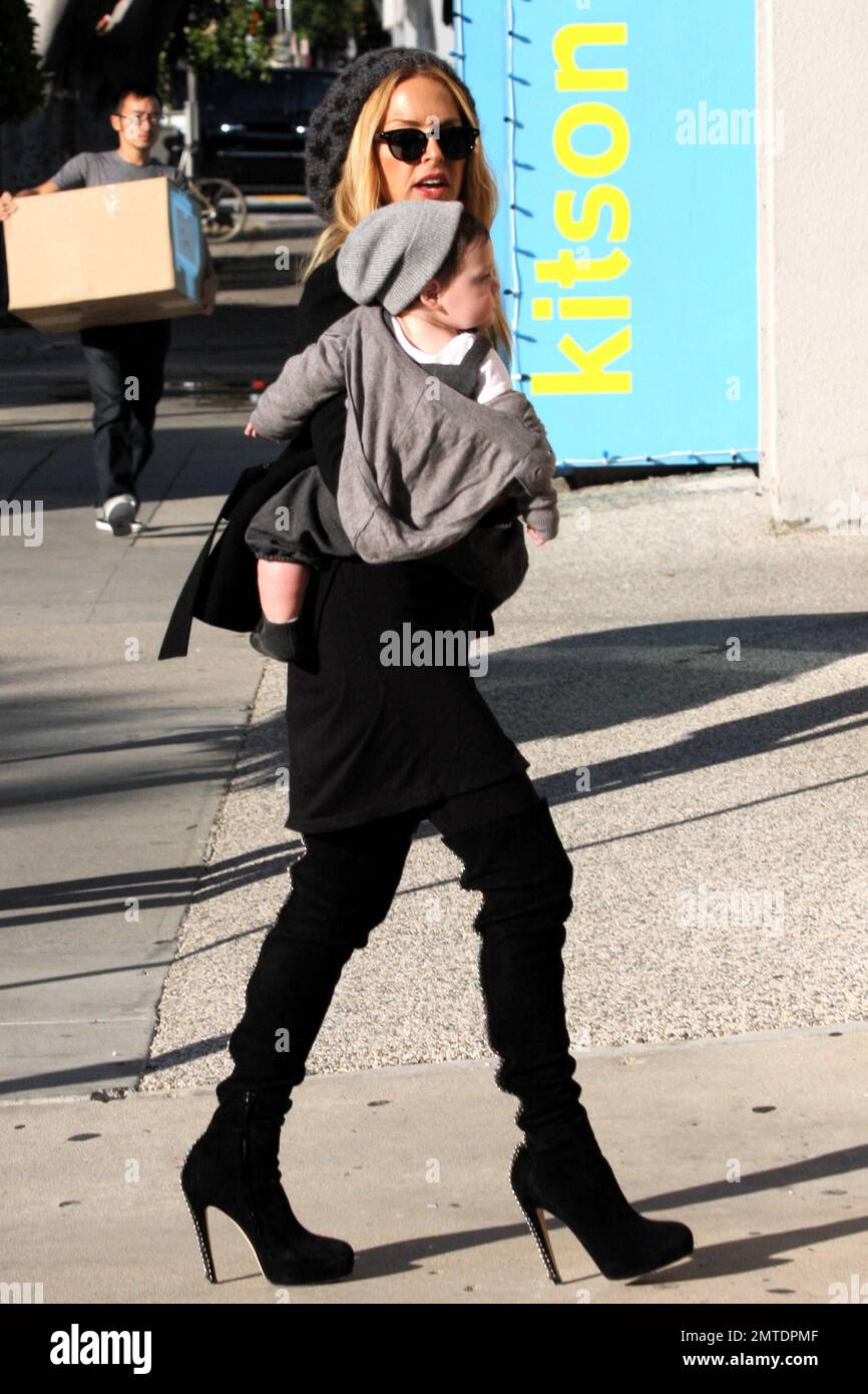 Celebrity stylist Rachel Zoe carries eight-month-old son Skyler Morrison  Berman in her arms during an outing in West Hollywood. Zoe wore a black  dress paired with a black jacket and black cap.