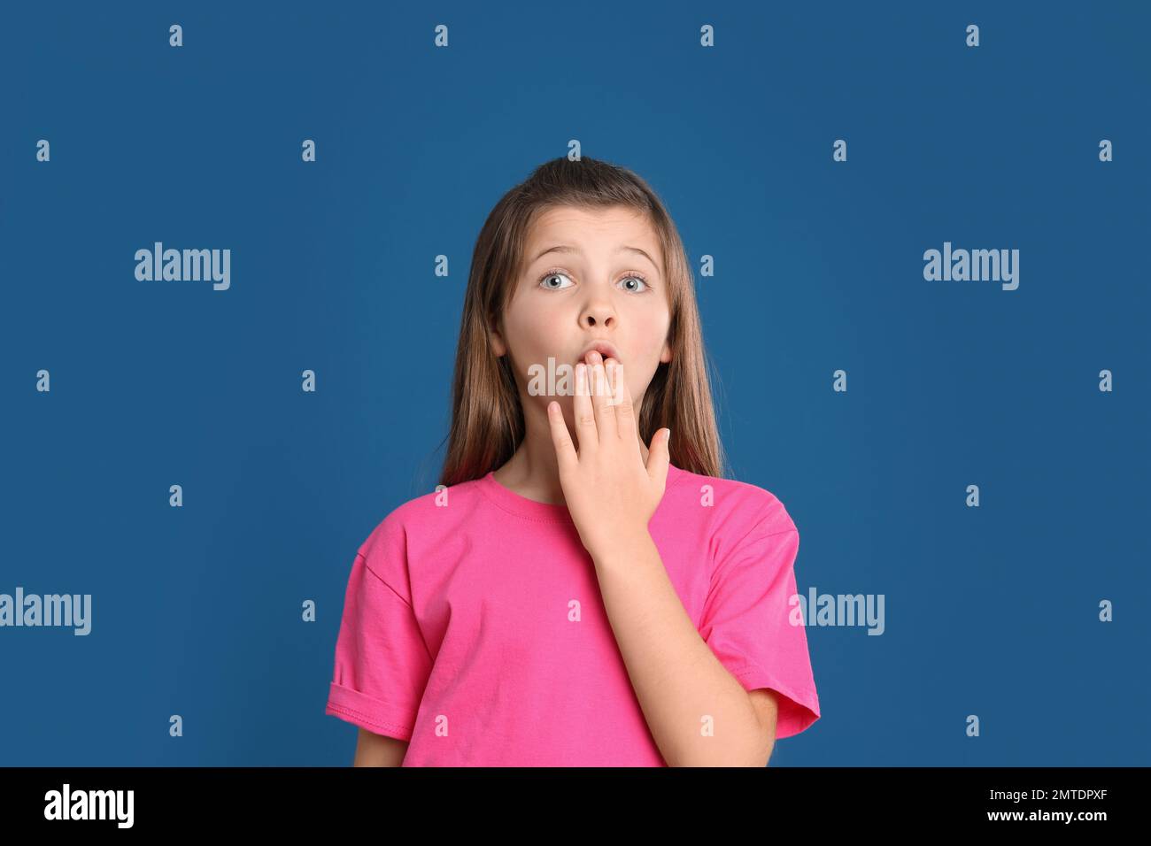 Portrait of emotional preteen girl on blue background Stock Photo - Alamy