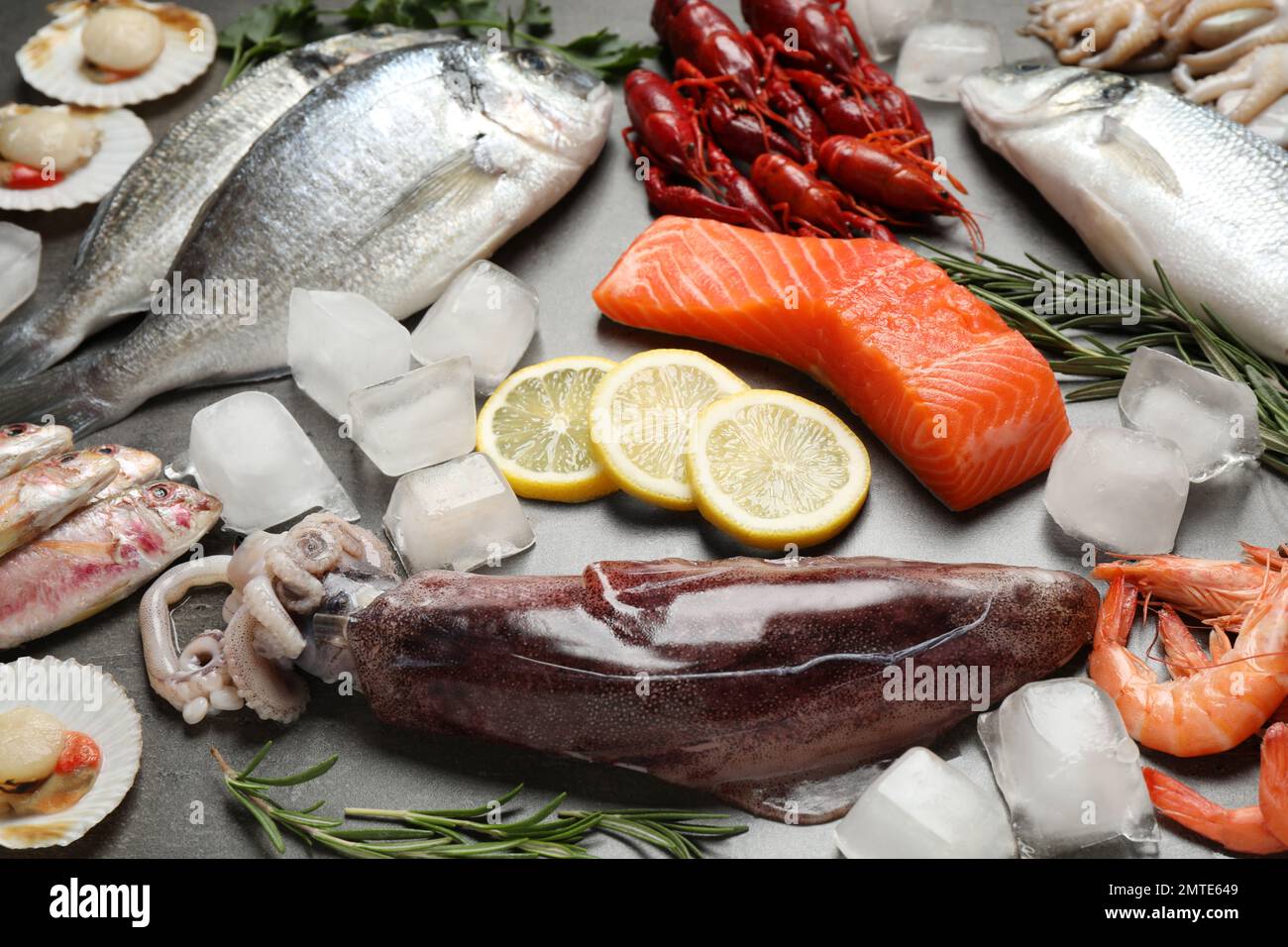 Fresh fish and seafood on grey table Stock Photo - Alamy