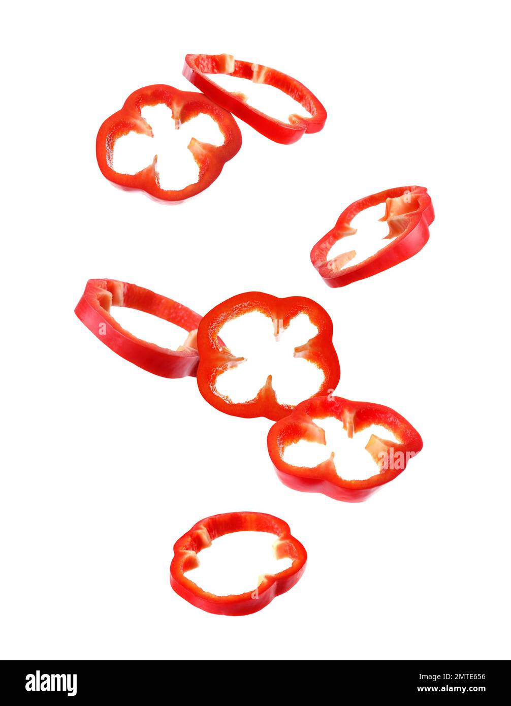 Falling cut red bell peppers on white background Stock Photo Alamy