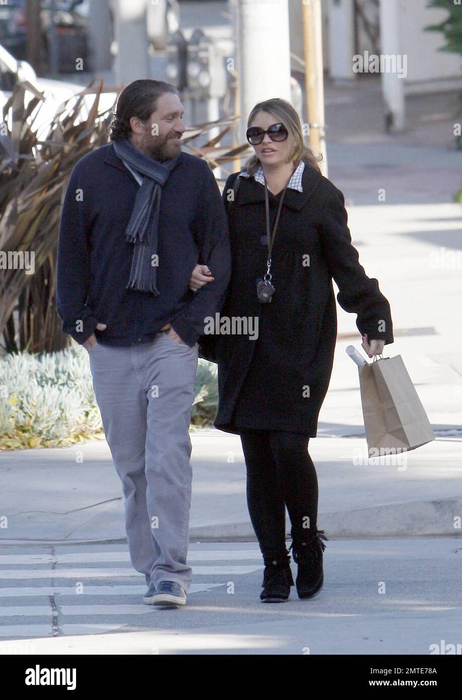 Actress Rebecca Gayheart and a male friend enjoy a walk on Melrose