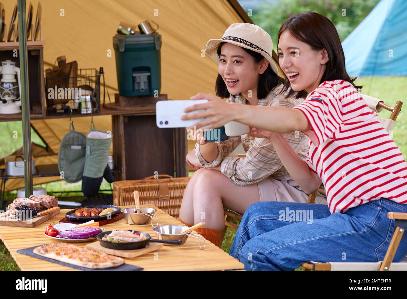 Young Japanese women at campsite Stock Photo