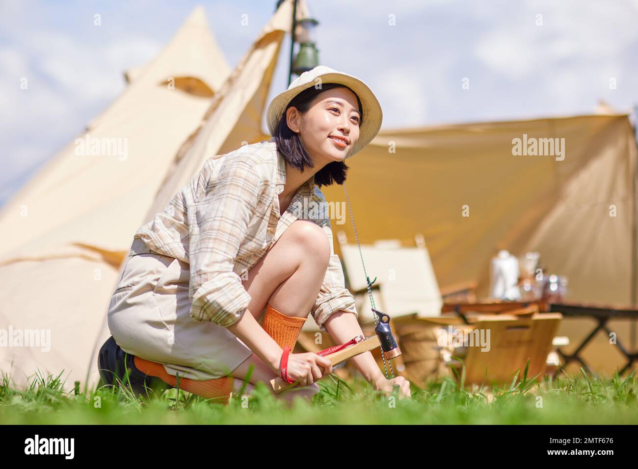 Young Japanese woman at campsite Stock Photo
