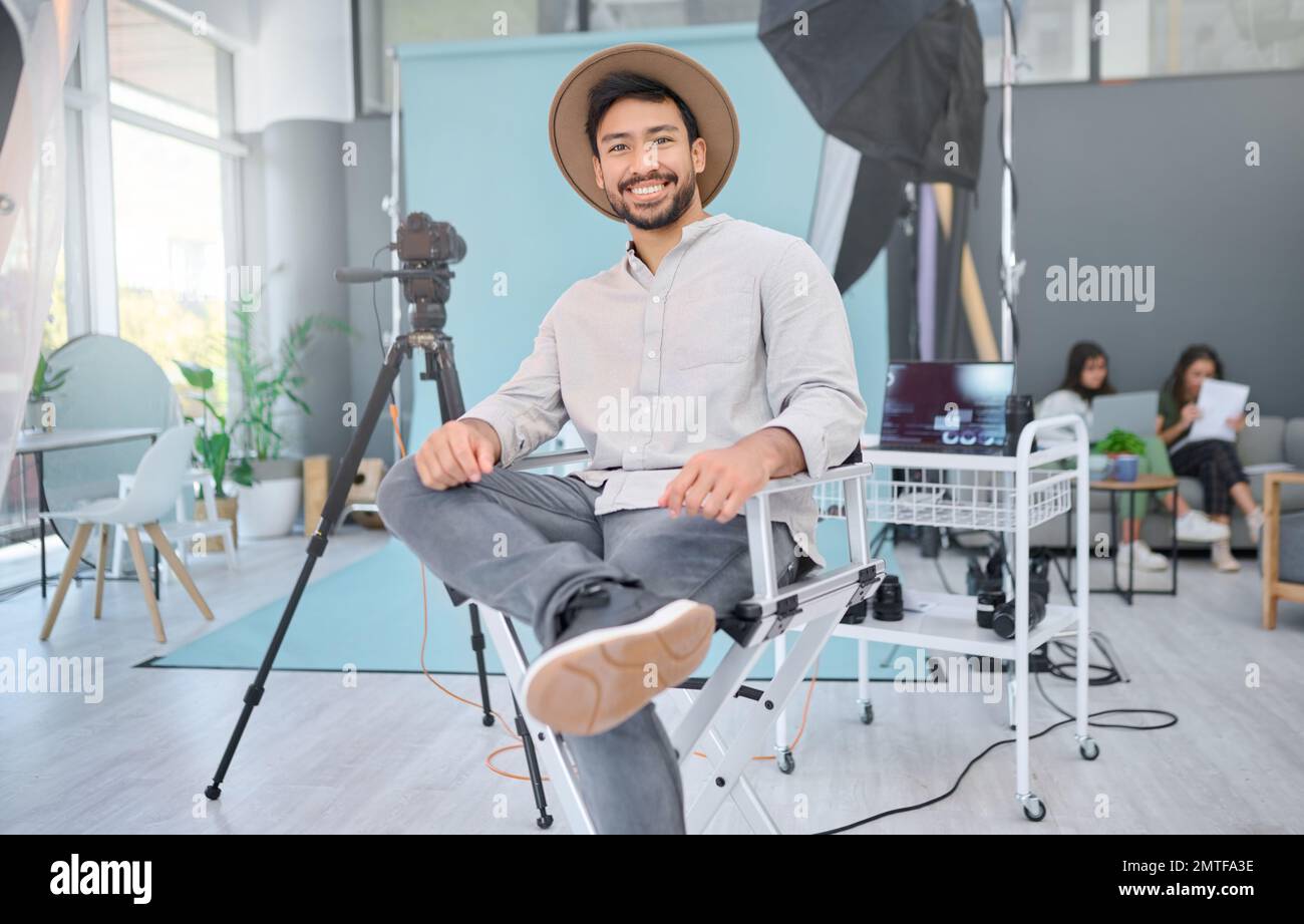 Portrait, happy and photographer in studio for photo shoot, relax and confident in professional setup. Face, asian male and magazine photography Stock Photo