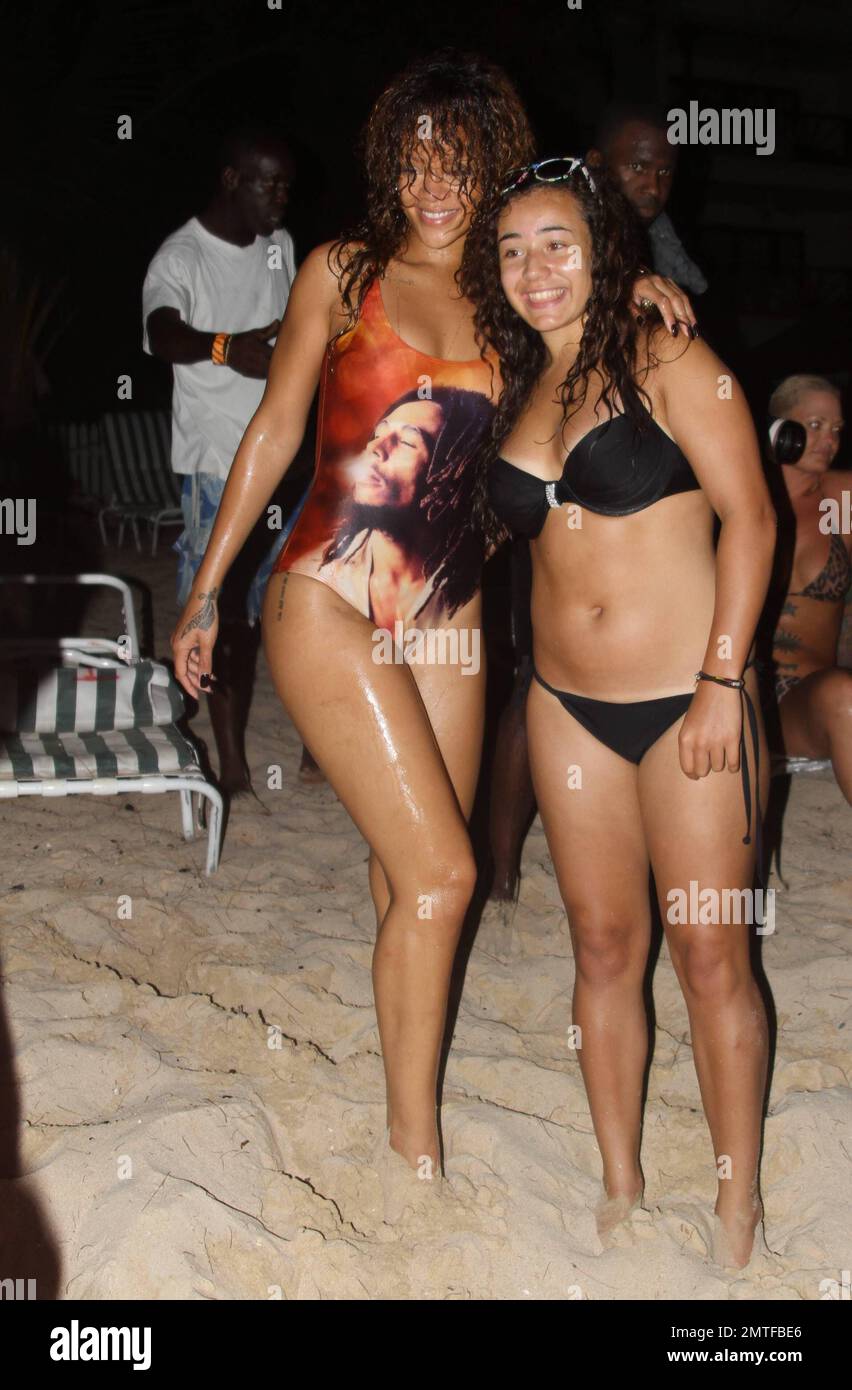 Rihanna wearing a Bob Marley one piece swimsuit, swam to shore from a yacht  and told a beach bartender that he had "3 minutes to get her a beer". She  posed for