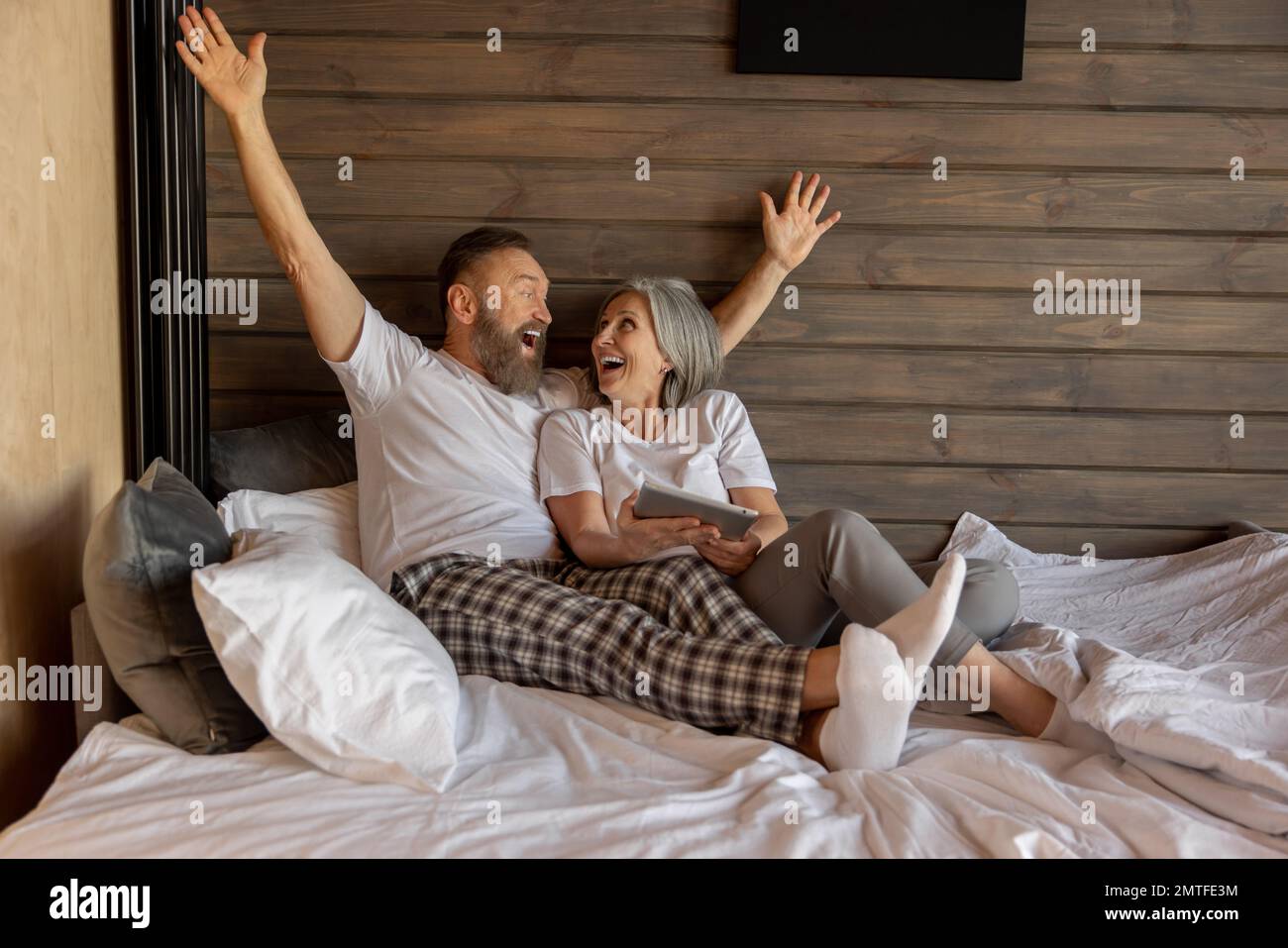 Mature couple at home in the morning feeling excited Stock Photo